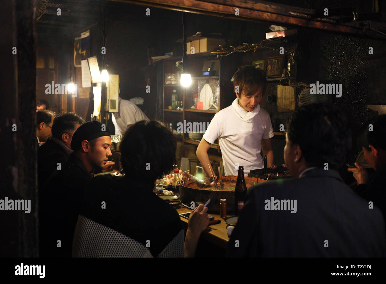 Unidentified men drinking at a restaurant bar in Tokyo, Japan Stock Photo