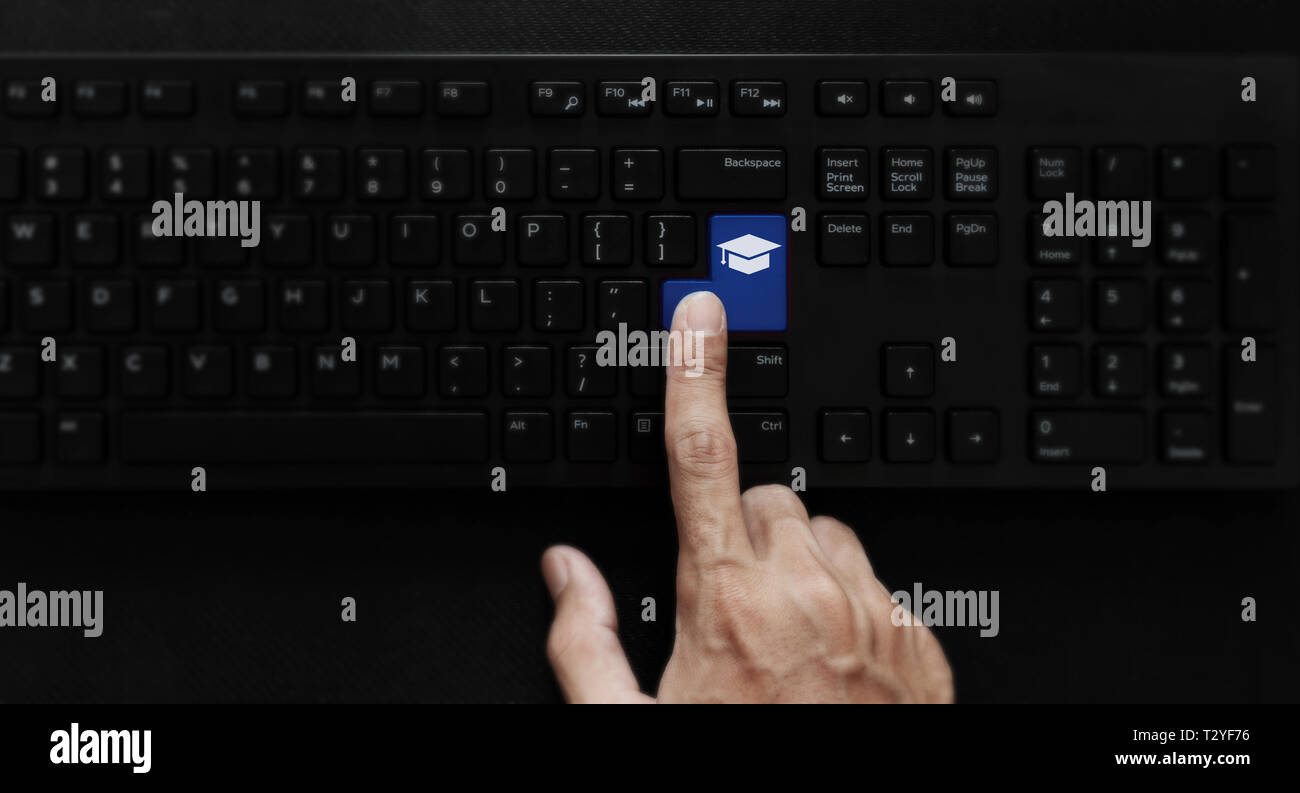 E-learning, online education and online studying course. Hand pressing education icon on computer keyboard Stock Photo