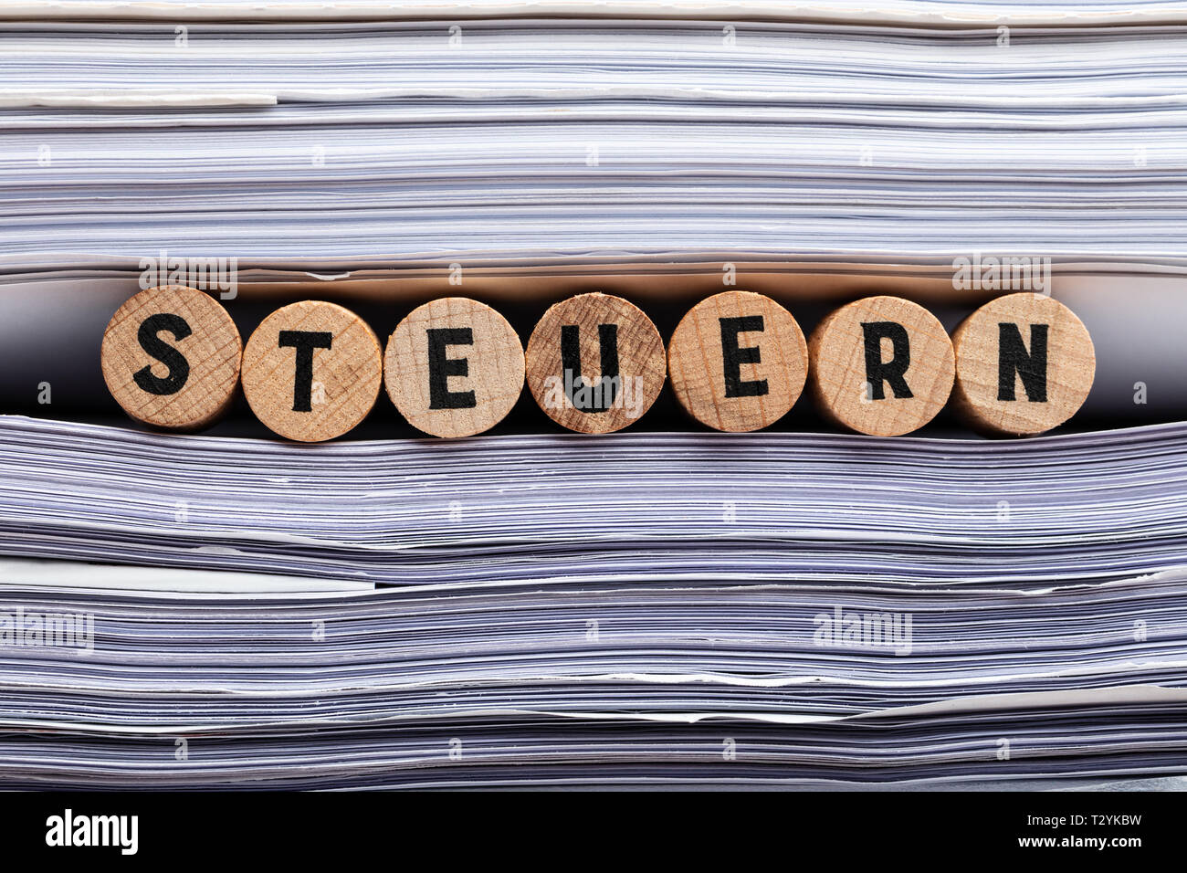 German word for Tax. Detail Shot Of Steuern Word Between Stacked Documents Stock Photo