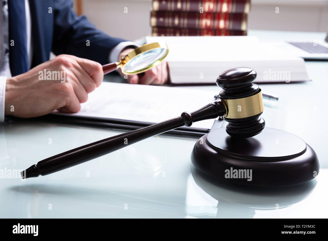Male Justice Working On Legal Documents With Gavel In The Courtroom Stock Photo