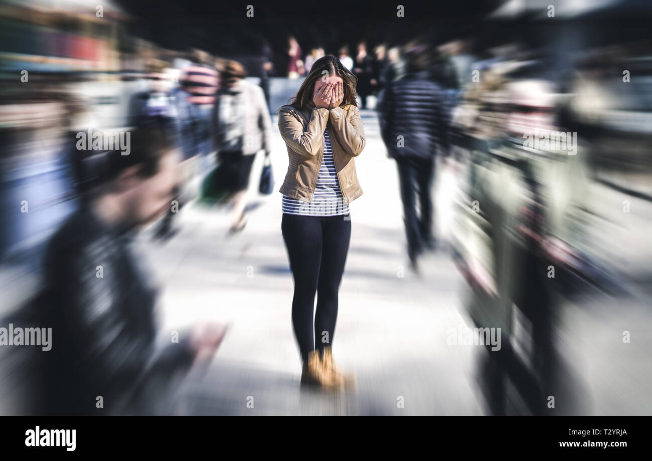 Panic attack in public place. Woman having panic disorder in city. Psychology, solitude, fear or mental health problems concept. Depressed sad person. Stock Photo