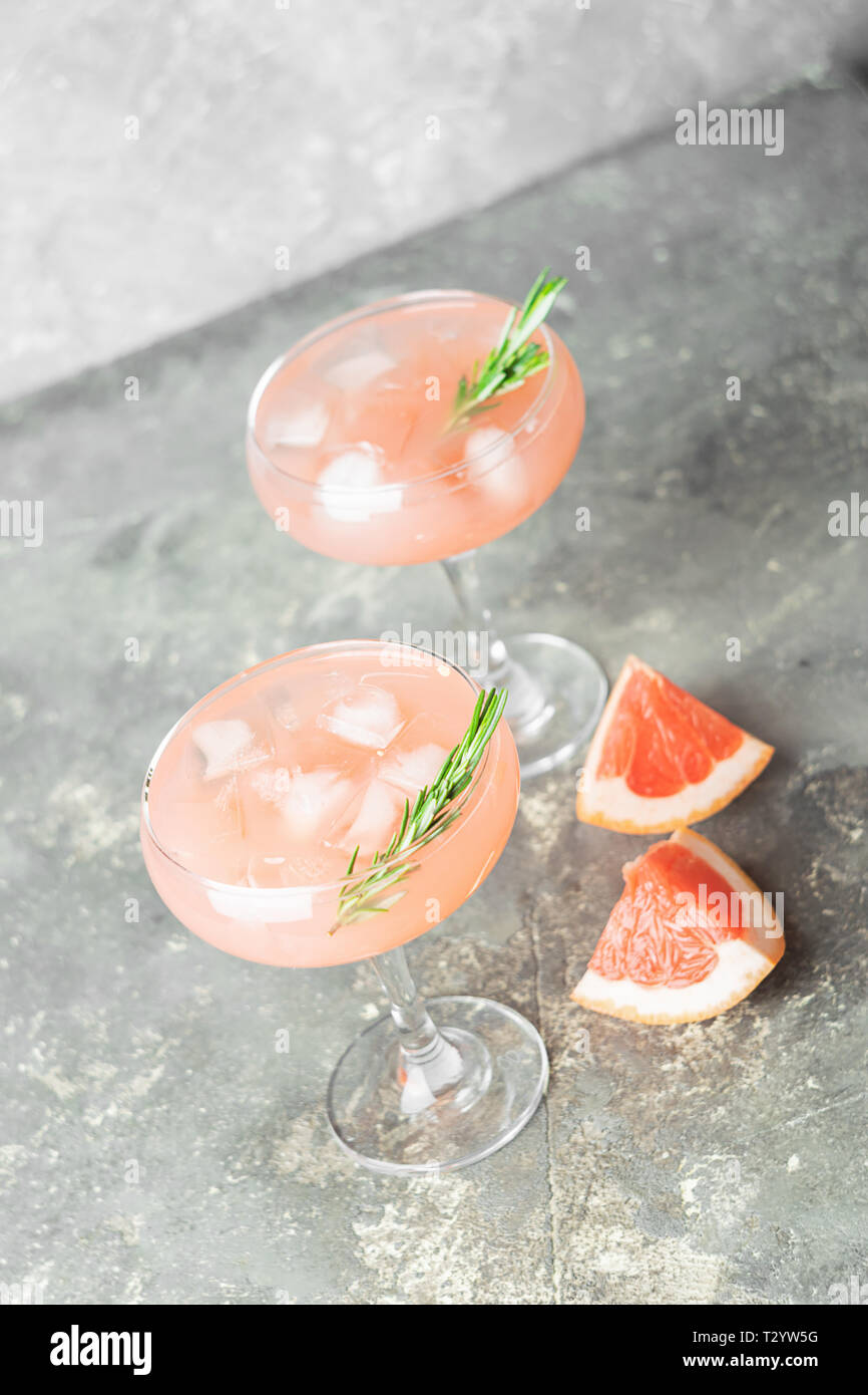 A refreshing summer cocktail of grapefruit rosemary and ice juice in ...