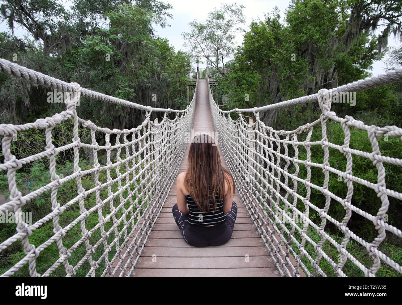meditating on a bridge while hiking in wildlife refuge Stock Photo