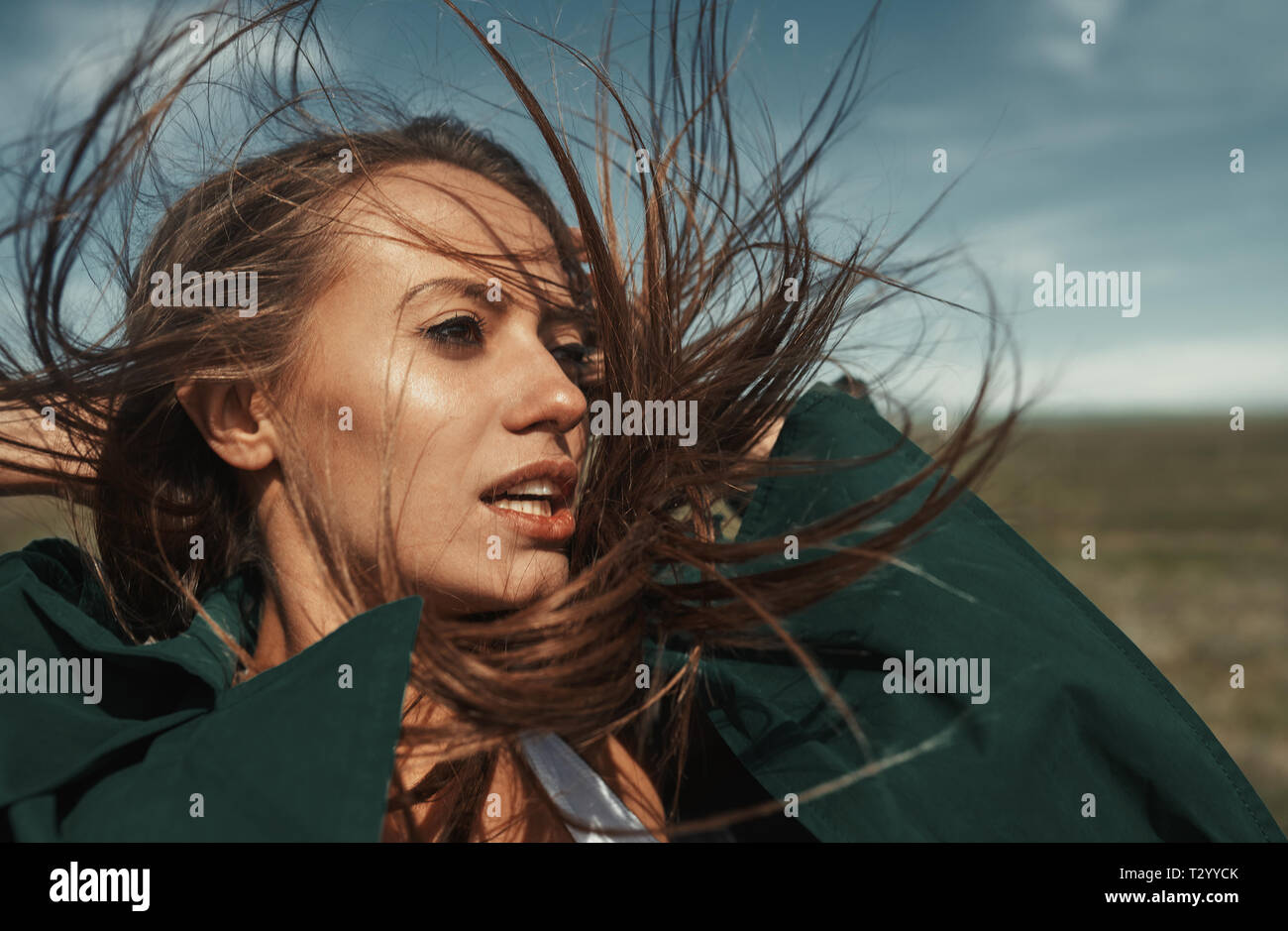 Woman outdoors with tousled wind blown hairs Stock Photo