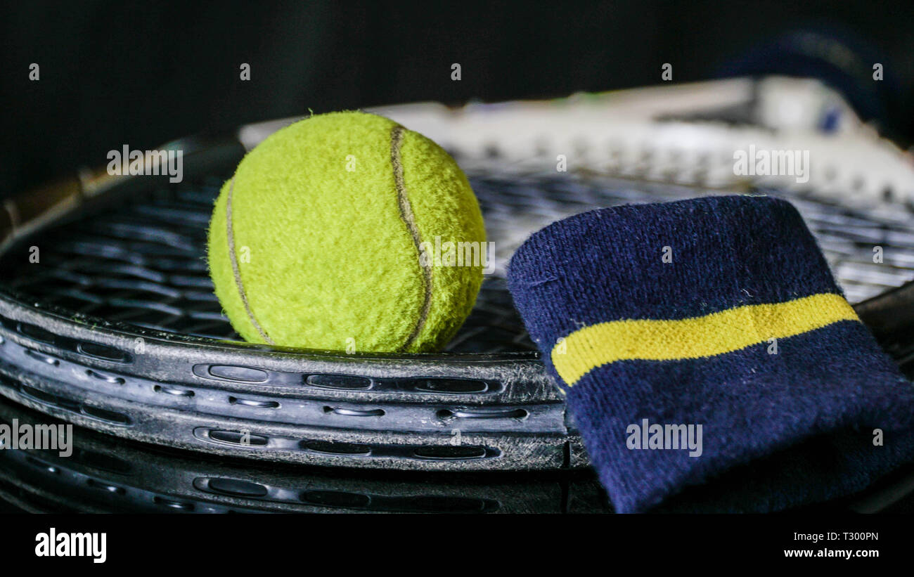 Old or used tennis ball, racket tennis and hand wrist strap isolated in ...