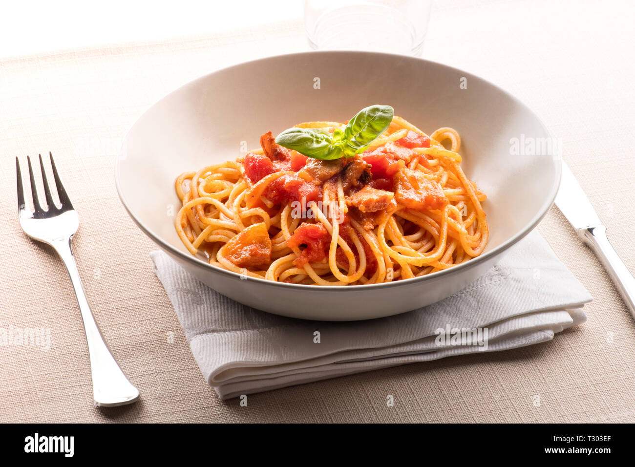 Spaghetti all' amatriciana from the Lazio region of Italy with pecorino cheese, pepper, tomato, cured pork jowl or guanciale served in a bowl as a fir Stock Photo