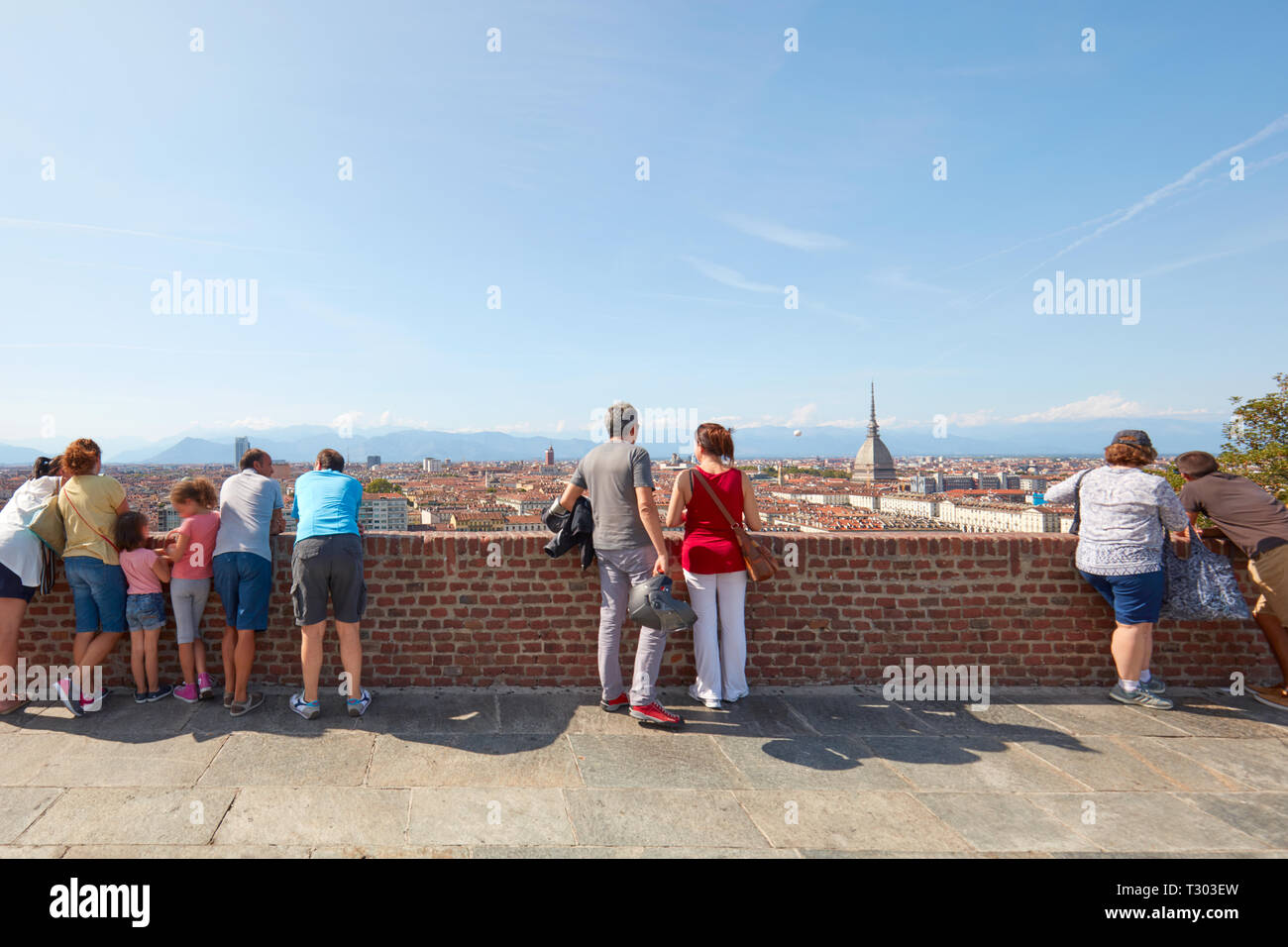 TURIN, ITALY - AUGUST 20, 2017: People and tourists looking at Turin skyline from Cappuccini hill balustrade in a sunny day in Italy. Stock Photo