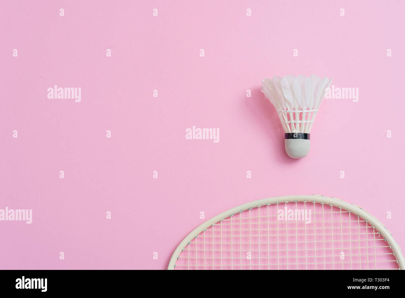 Badminton racket and shuttlecock on a pink background Stock Photo - Alamy