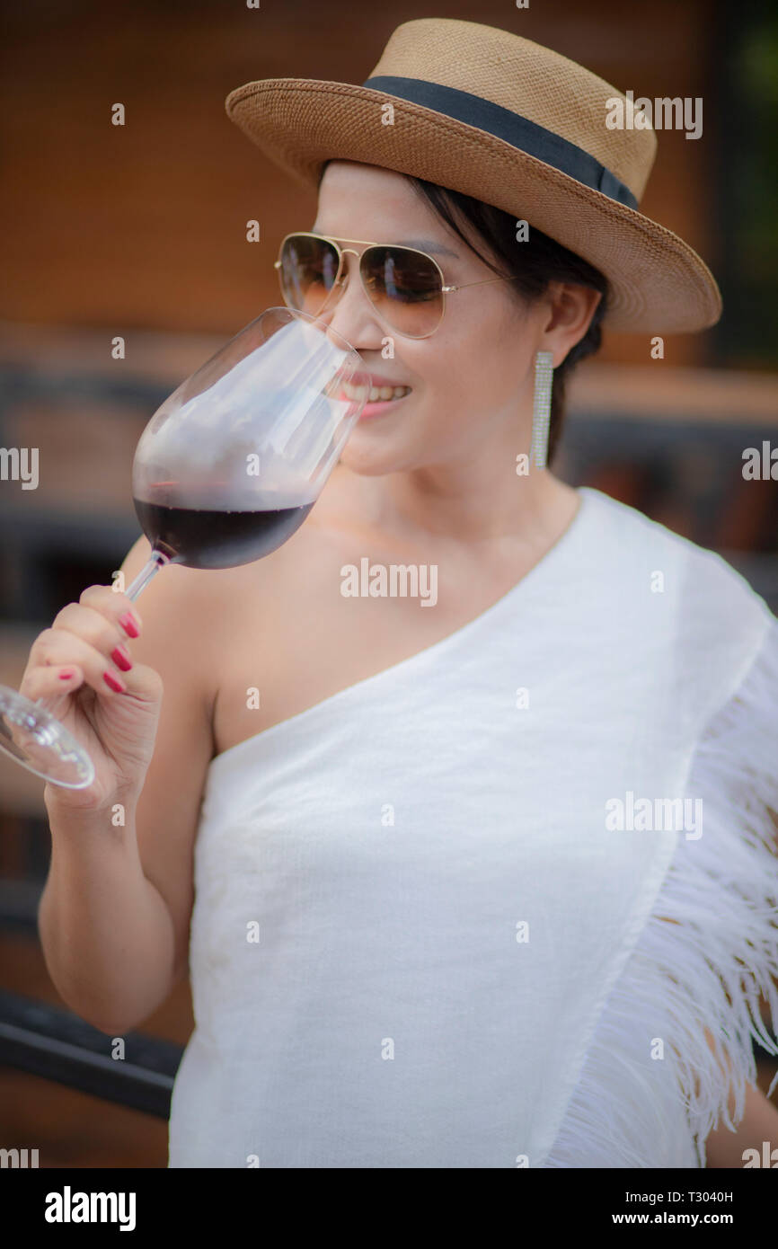 beautiful asian woman drinking red wine in wine glass Stock Photo - Alamy