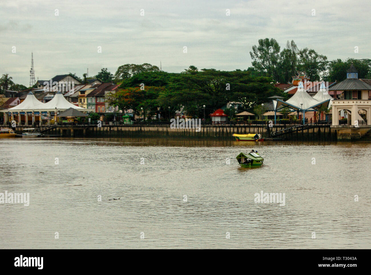 A boat crossing the Sarawak River in the city of Kuching, Sarawak Stock Photo