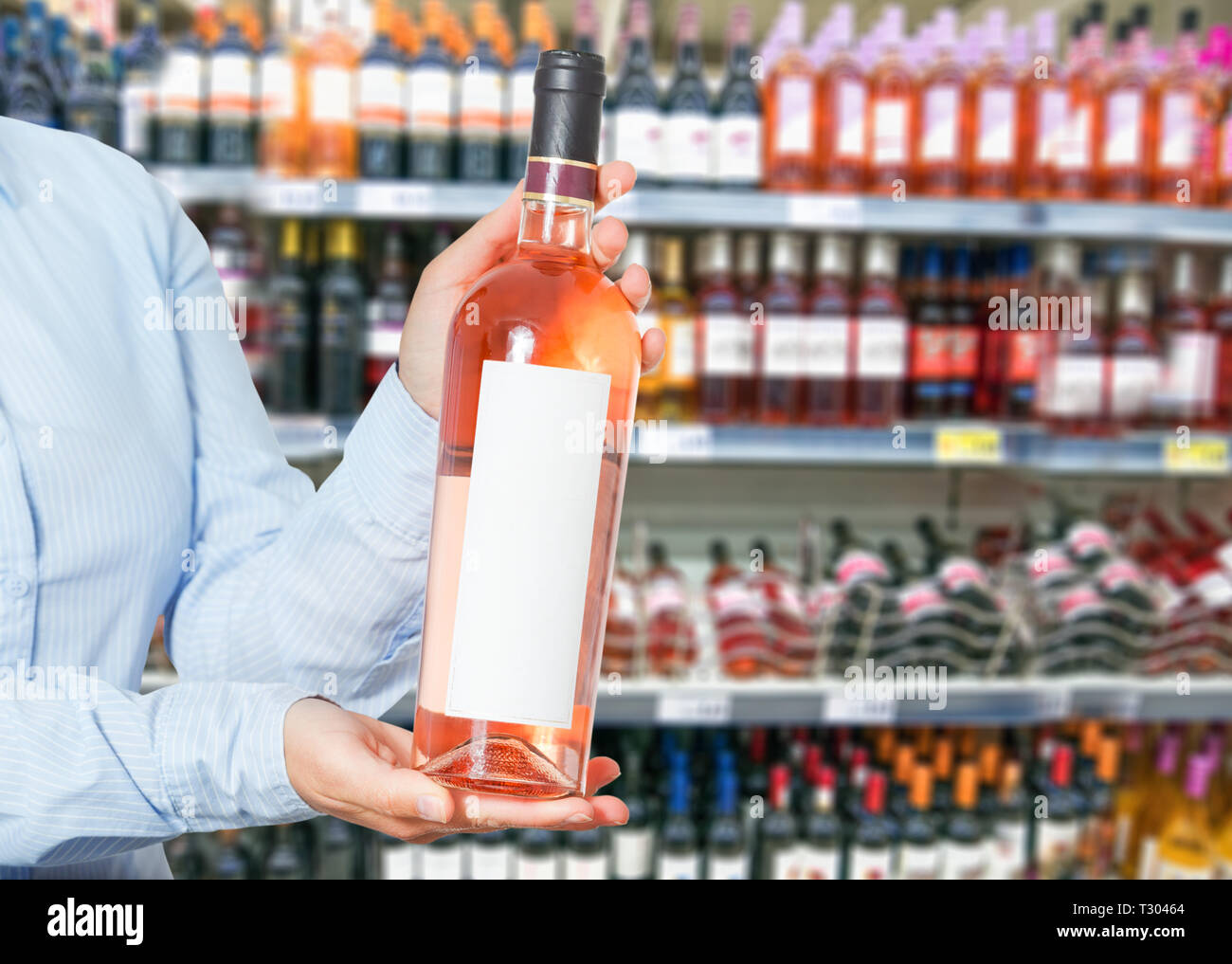 woman buys wine in shop Stock Photo