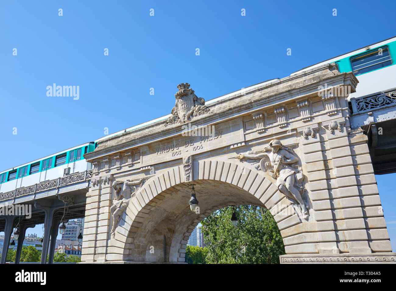 Bir Hakeim bridge and metro train passing in a sunny summer day in Paris, France Stock Photo