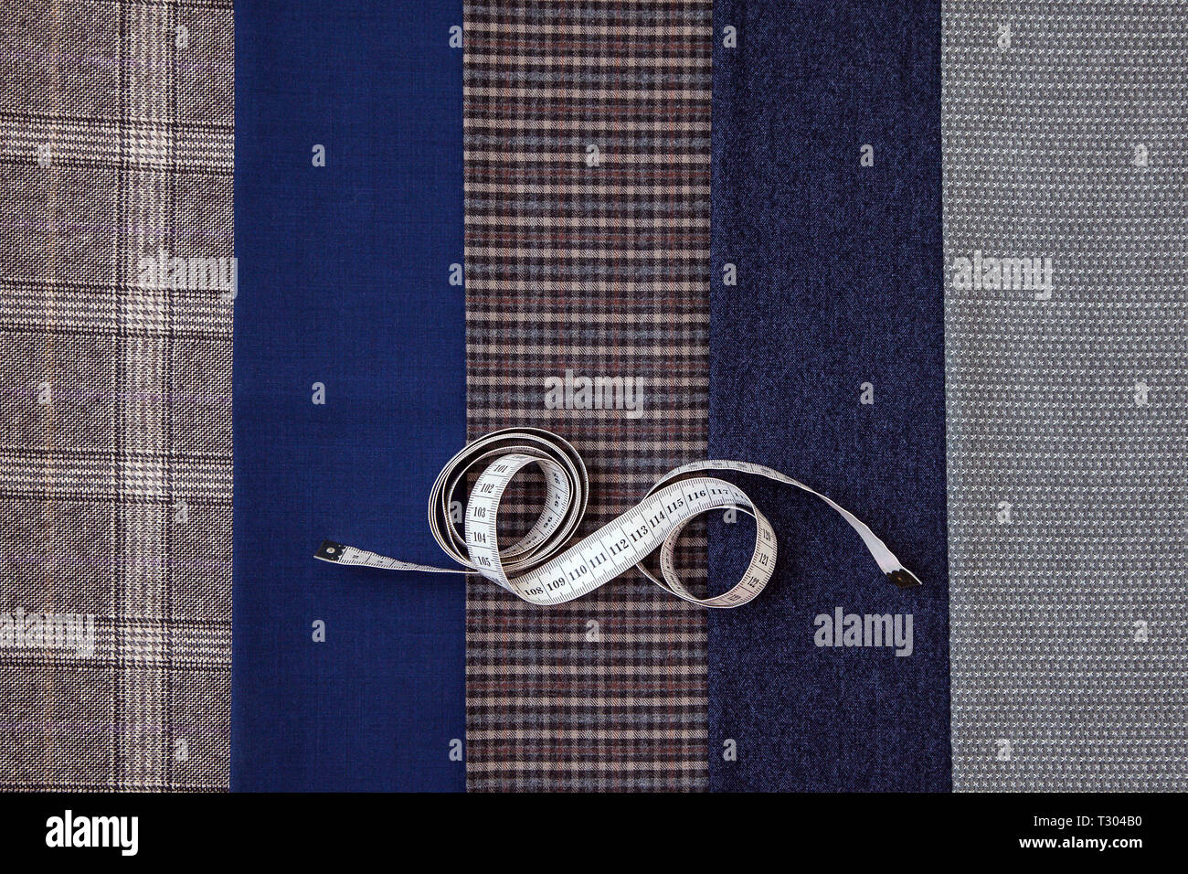 Many different in color threads lie on the sewing table along with the ...