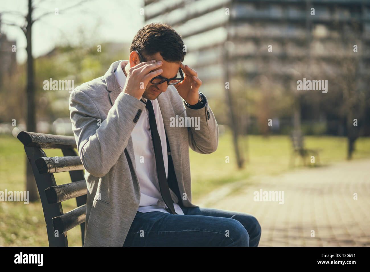 Young businessman is having headache. Stock Photo