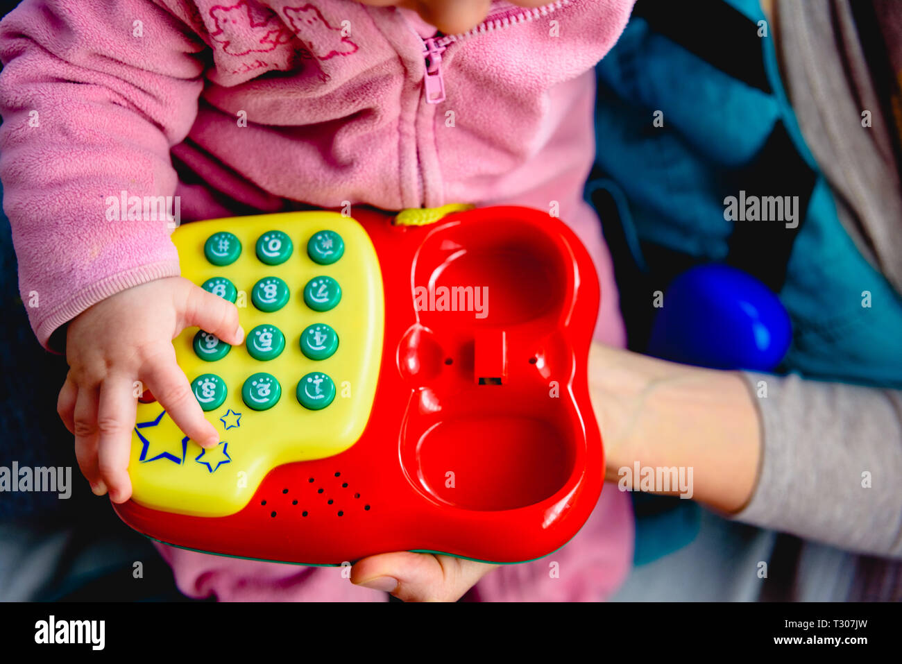Red toy phone to entertain a baby Stock Photo - Alamy
