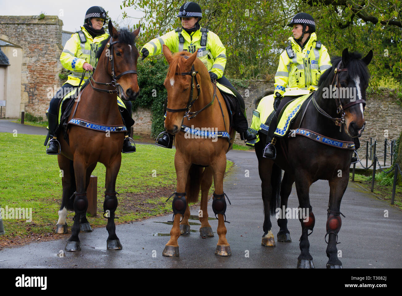 Mounted Police Officers preparing for a photography session at the Bishop's Palace in Wells, Somerset, UK Stock Photo