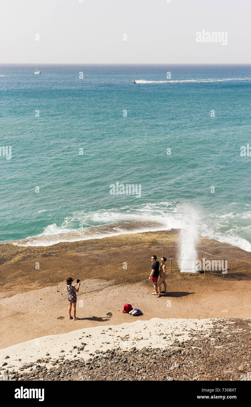 Tourists Take Photos At A Water Spout Beside Playa De Fanabe