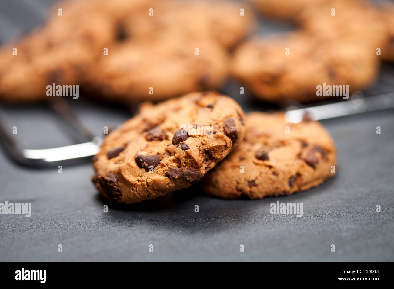Baking grid with chokolate cookies on blackboard background. Stock Photo