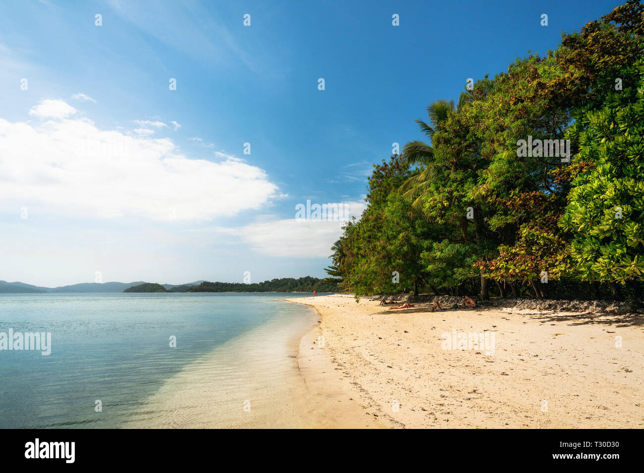 Sandy wild beach with turquoise water and green trees on tropical Cagsalay island, Philippines Stock Photo