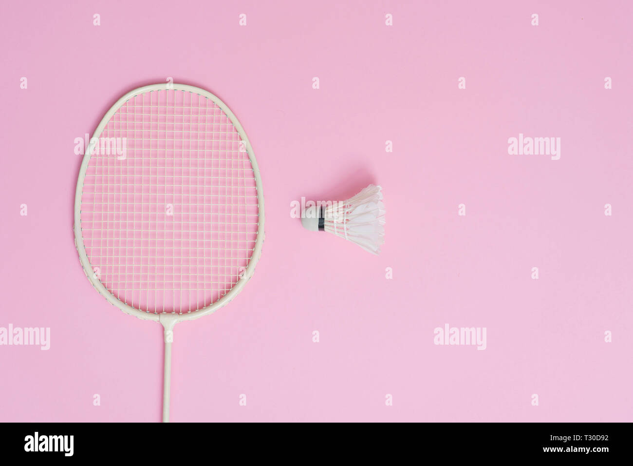 Badminton racket and shuttlecock on a pink background Stock Photo - Alamy