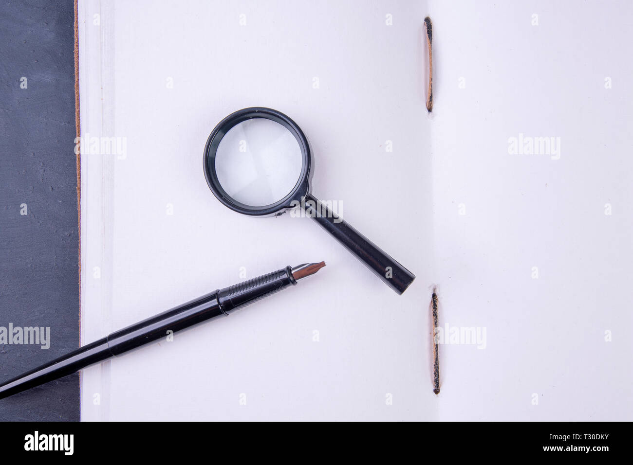 open empty book hand-bound with magnifying glass and fountain pen Stock ...