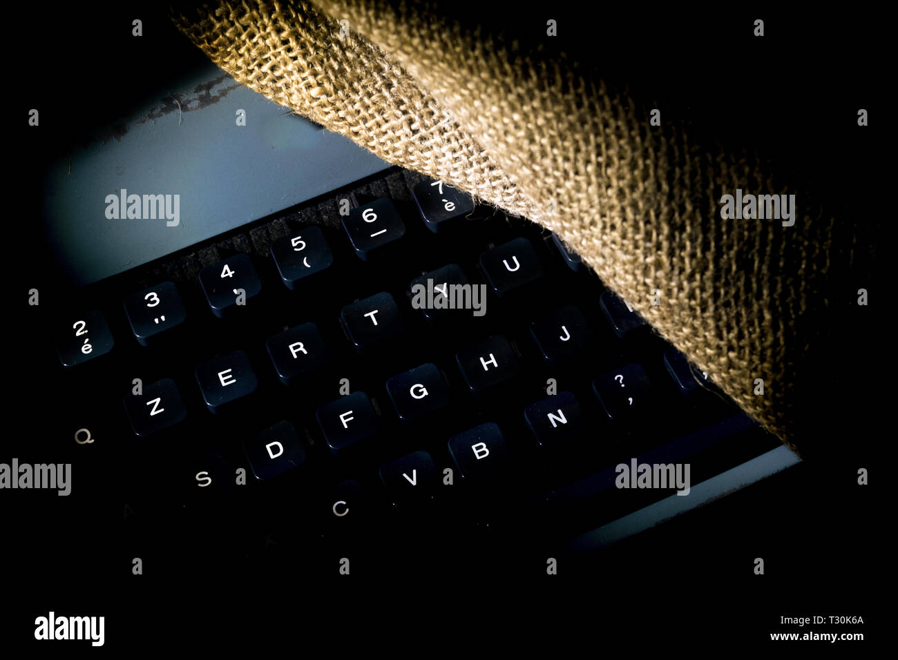 keyboard of an old typewriter lit with drammatic light Stock Photo