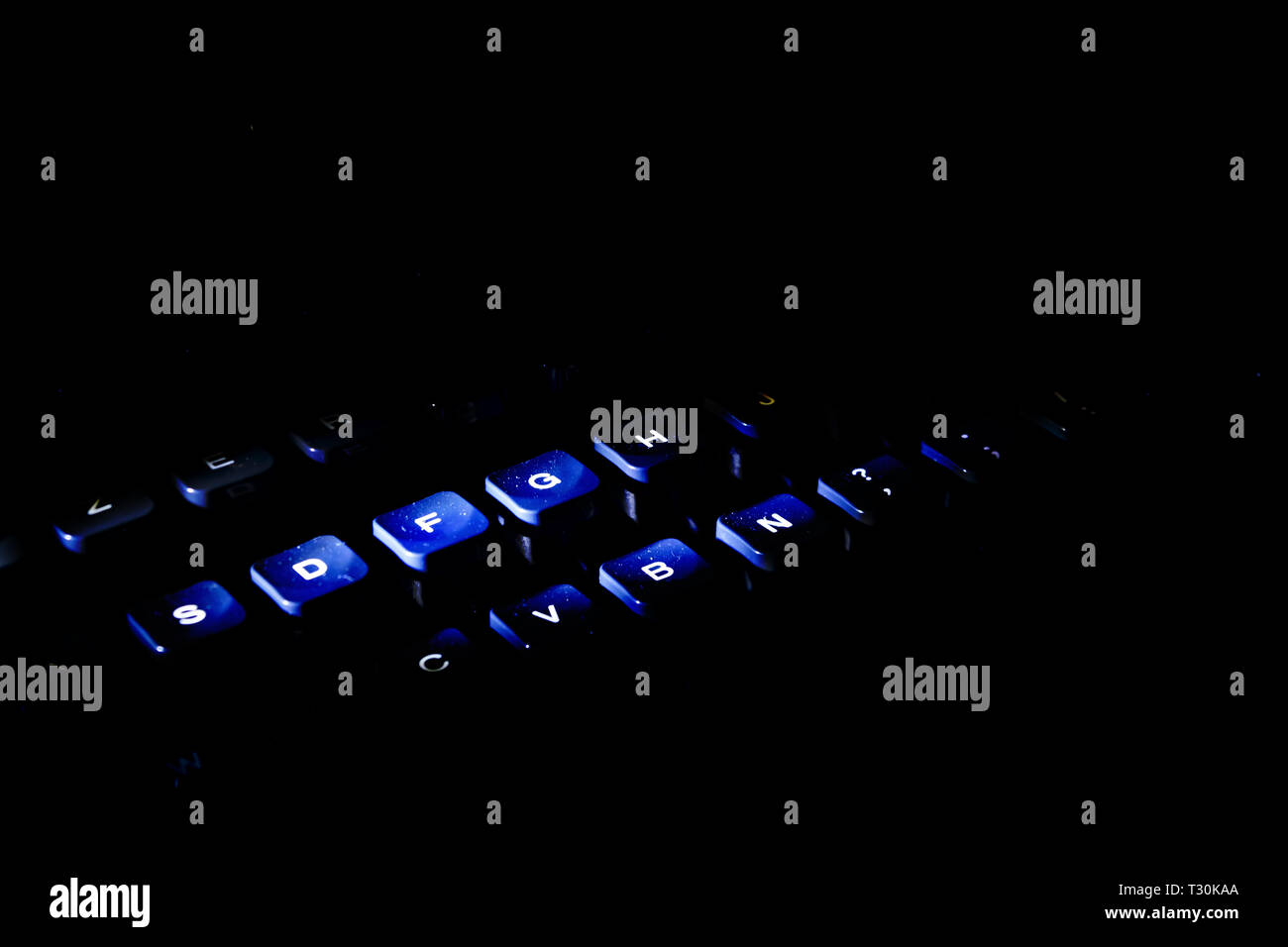 keyboard of an old typewriter lit with drammatic light Stock Photo