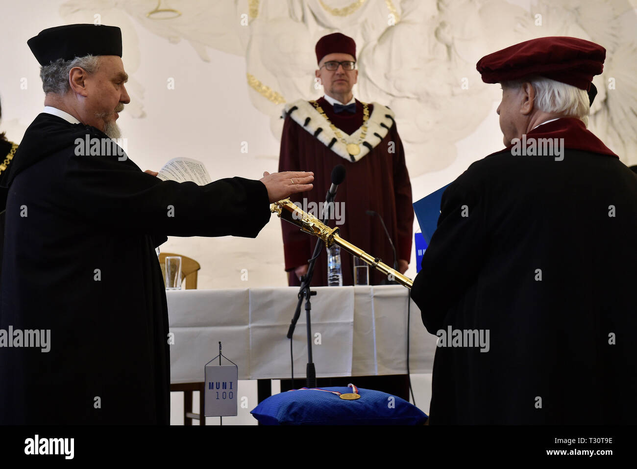 Brno, Czech Republic. 05th Apr, 2019. Masaryk University (MU) bestowed an honorary doctorate on Russian historian Andrei Zubov (left), a specialist in the history of religion, philosophy and Russia, for exceptional academic performance, the development of human knowledge and his public activities, on April 5, 2019, in Brno, Czech Republic. On the right side is seen bedel Jaroslav Gregd and in the center of the photo is seen MU Rector Mikulas Bek. Credit: Vaclav Salek/CTK Photo/Alamy Live News Stock Photo