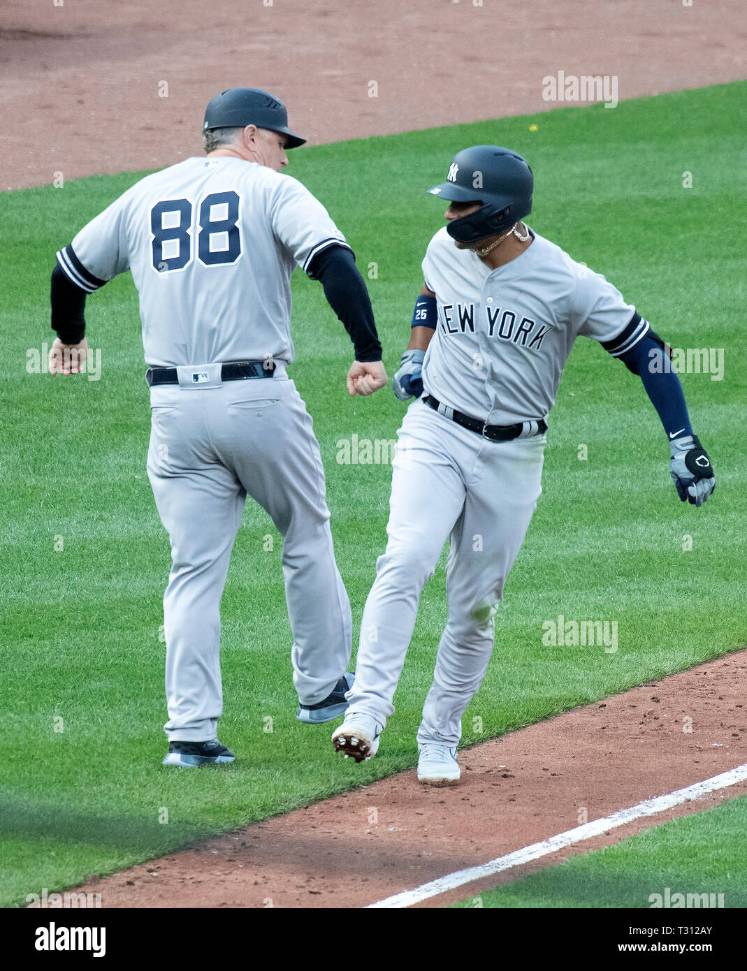 New York Yankees third base coach Luis Rojas (67) and designated hitter  Giancarlo Stanton (27) celebrate a home run during a MLB game against the  Los Stock Photo - Alamy