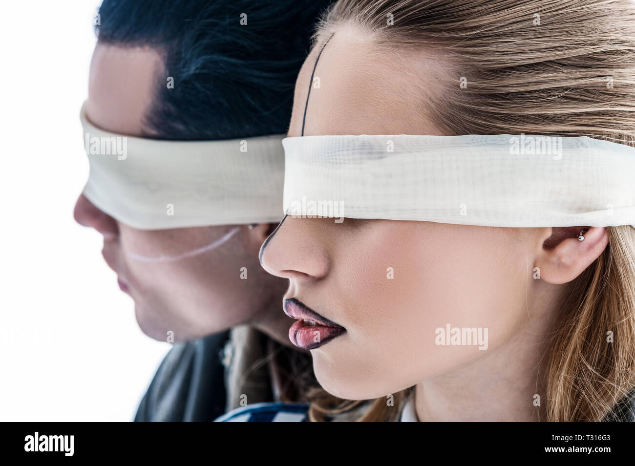 Male And Female Models Having Blindfolds And Lines On Face Stock