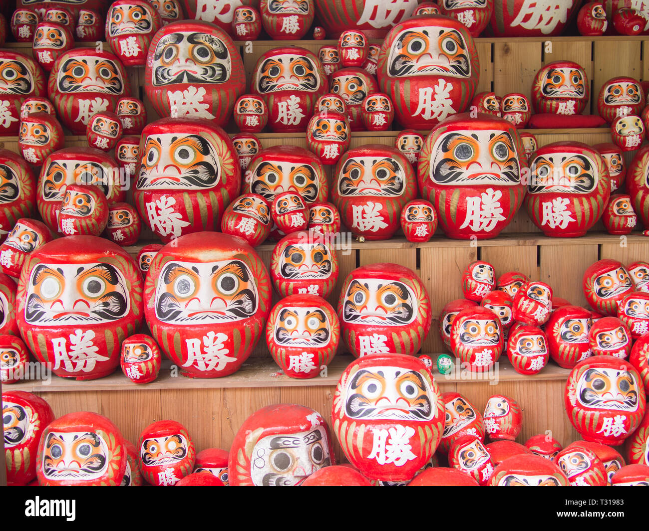 Daruma dolls at Katsuo-ji in Osaka Japan. People left these dolls at the temple ground hoping to obtain luck. Stock Photo