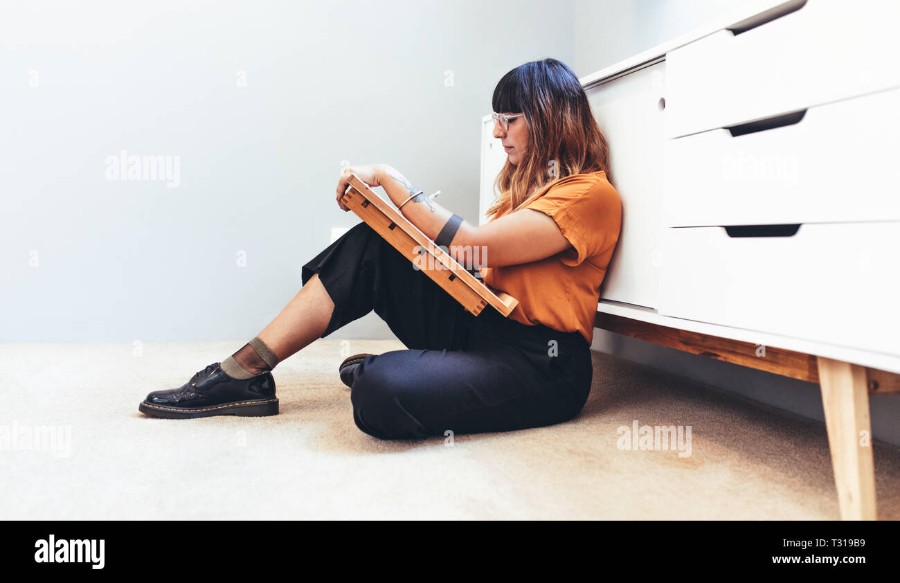 Side View Of A Female Creative Artist Sitting On Floor And Making A Drawing Illustrator Working On Her Designs Sitting Comfortably On Floor Stock Photo Alamy Side View Of A Female Creative Artist Sitting On Floor And Making A Drawing Illustrator Working On Her Designs Sitting Comfortably On Floor Stock Photo Alamy