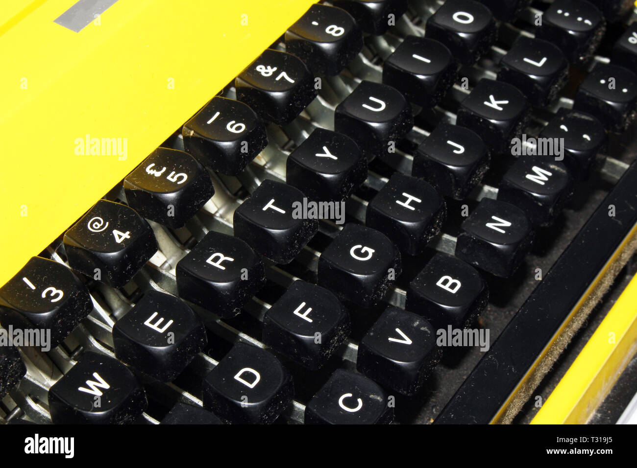 Retro Yellow Typewriter on a White Background Stock Photo