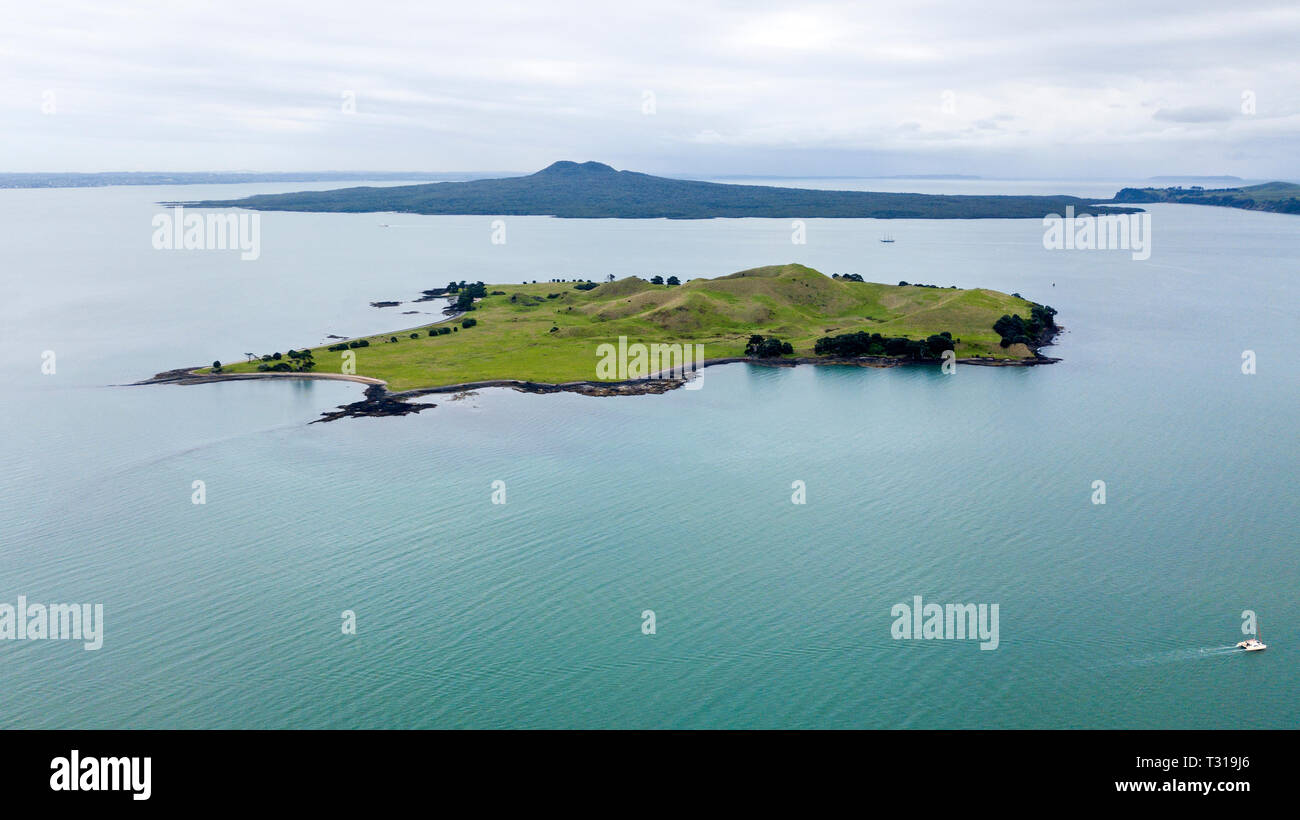 aerial shot of an island in the middle of the ocean with rangitoto island an extinct volcano as background, auckland, new zealand Stock Photo