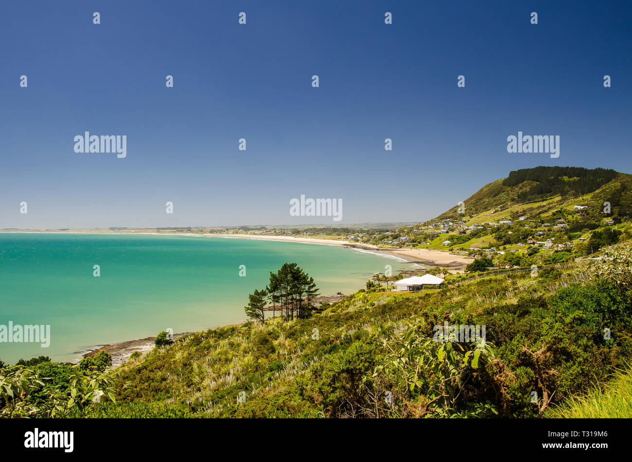 View from the Shipwreck Bay to the Ninety Mine Beach with blue sky above, Northland, New Zealand. Stock Photo