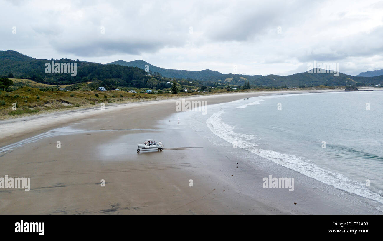 aerial view of a sea leg (boat) coming back from fishing in one of the