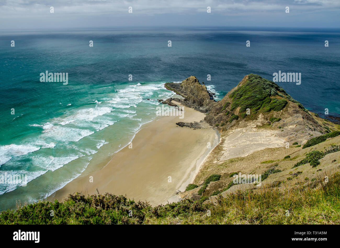 Coastline view from Cape Reinga with blue sky and white clouds above, Northland, New Zealand. Stock Photo