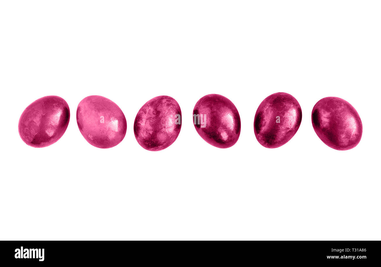 Pink Easter eggs in a row on isolated white background. Flat lay. Copy ...