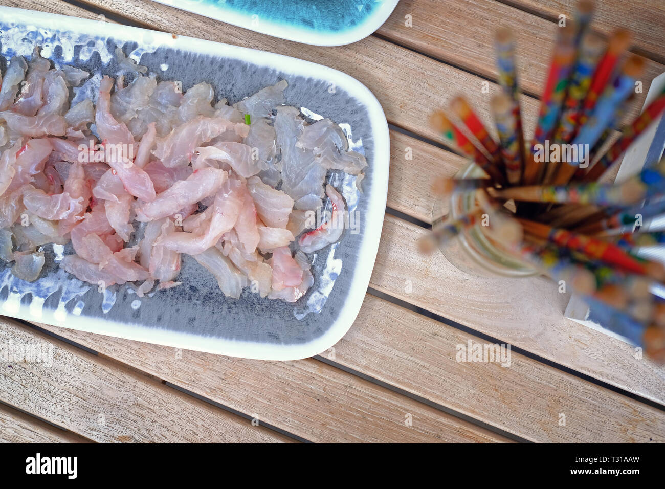 shot of fresh snapper sashimi with chopstick and soy sauce Stock Photo