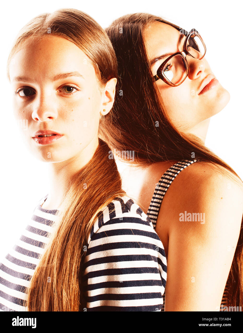 two young workers isolated on white, wearing same dresses in strip, glasses Stock Photo