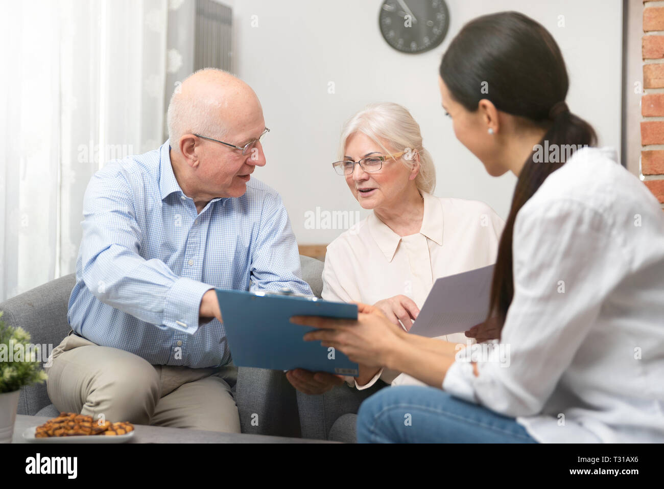 Senior couple planning their investments with financial advisor Stock ...