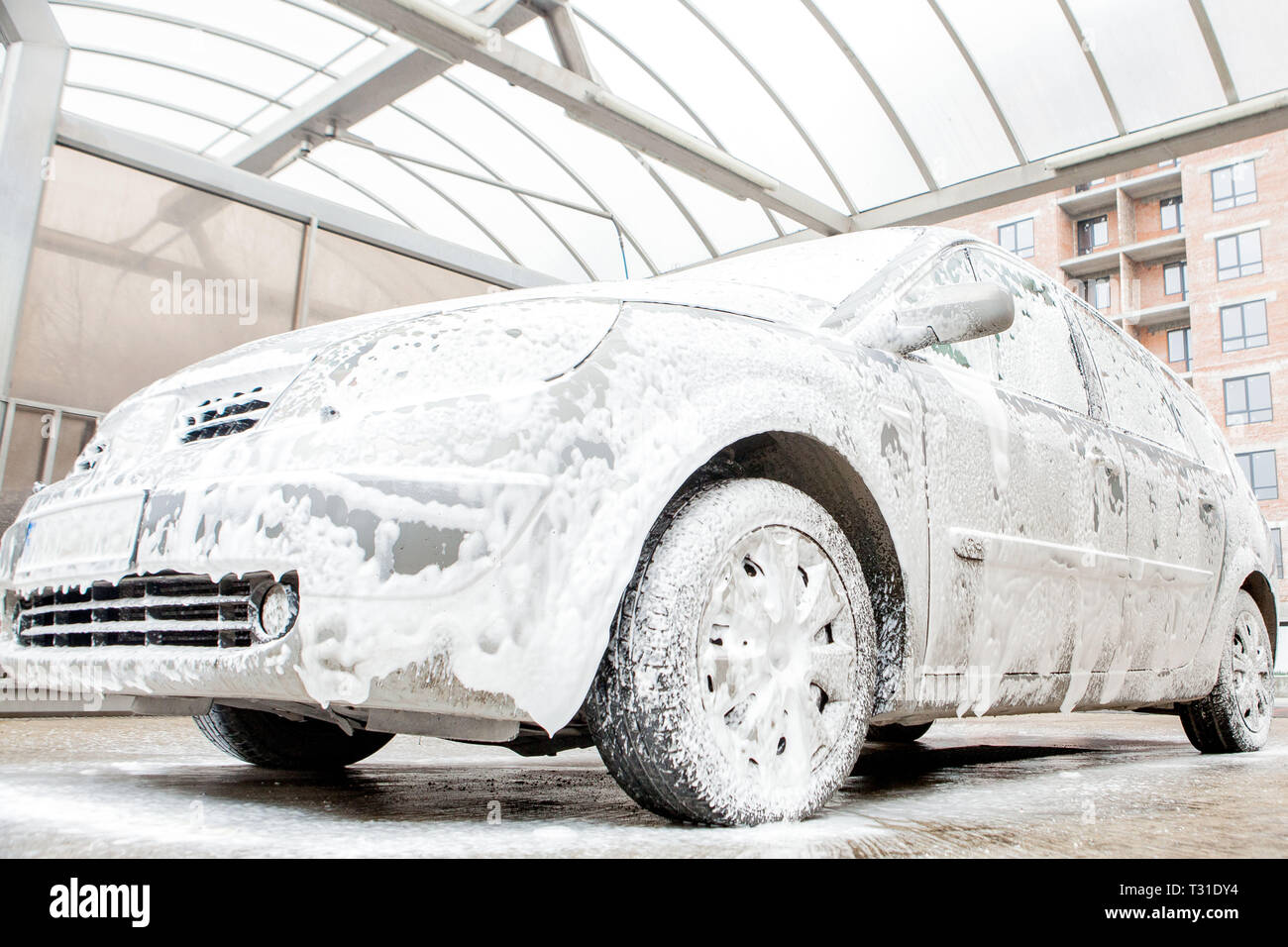 Car wash with foam in car wash station. Carwash. Washing machine