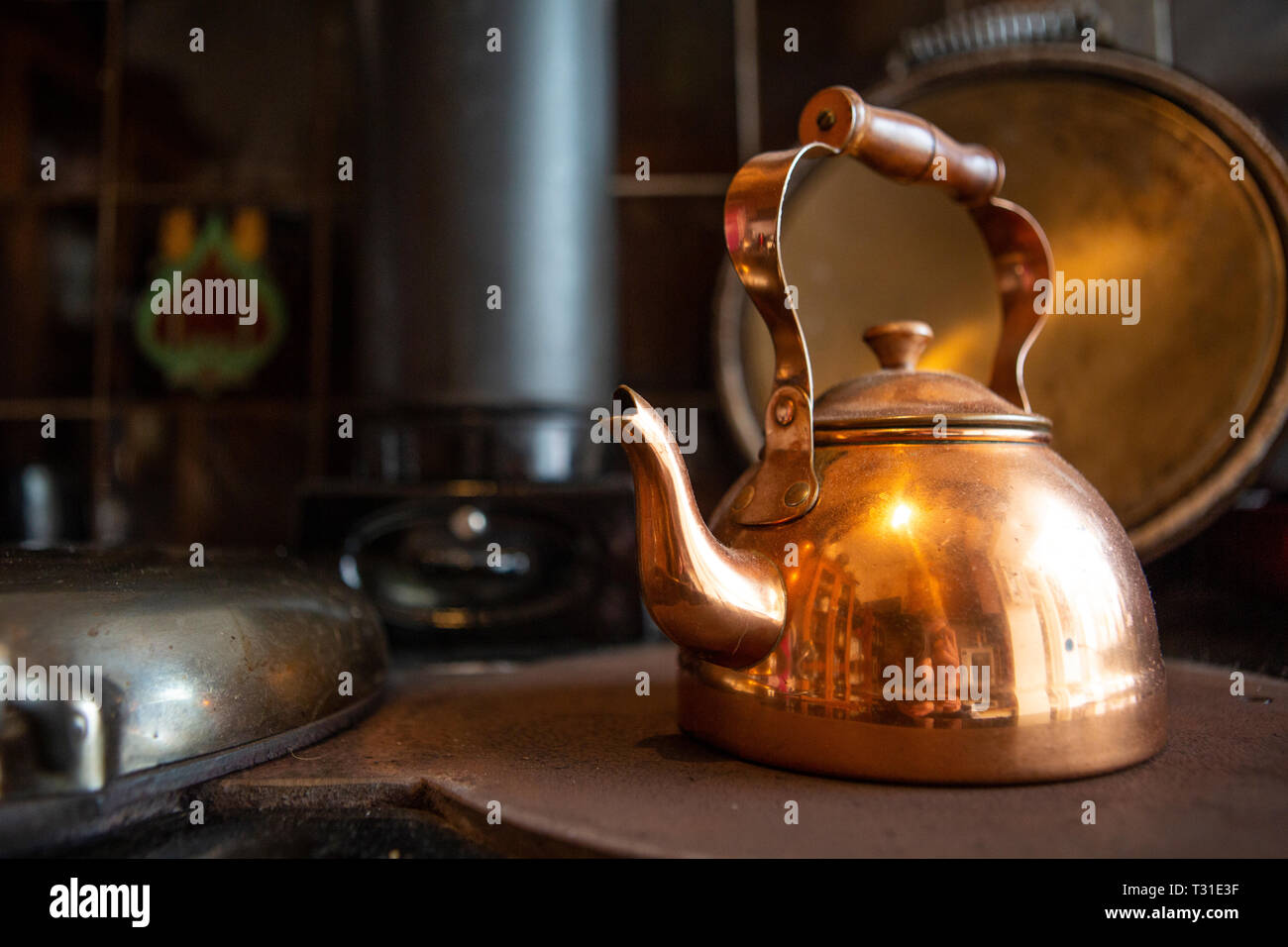 Copper kettle on stove Stock Photo Alamy