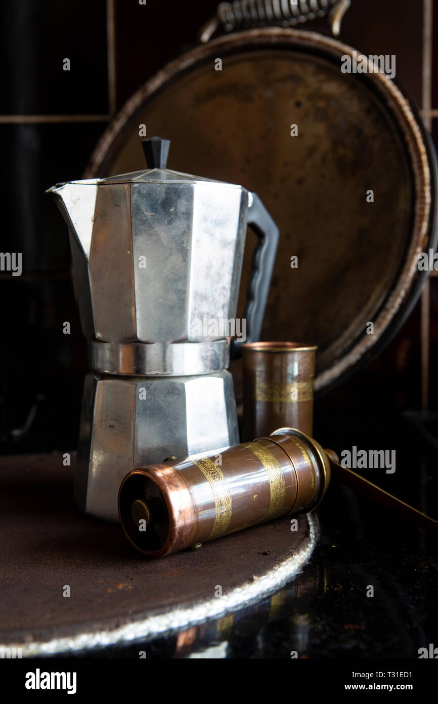Moka coffee pot on a stove with coffee grinder Stock Photo Alamy