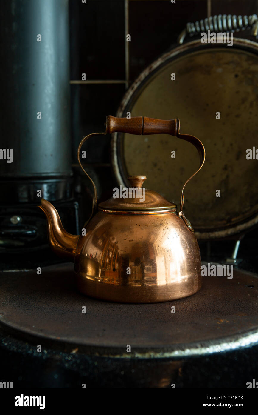 Copper kettle on stove Stock Photo - Alamy