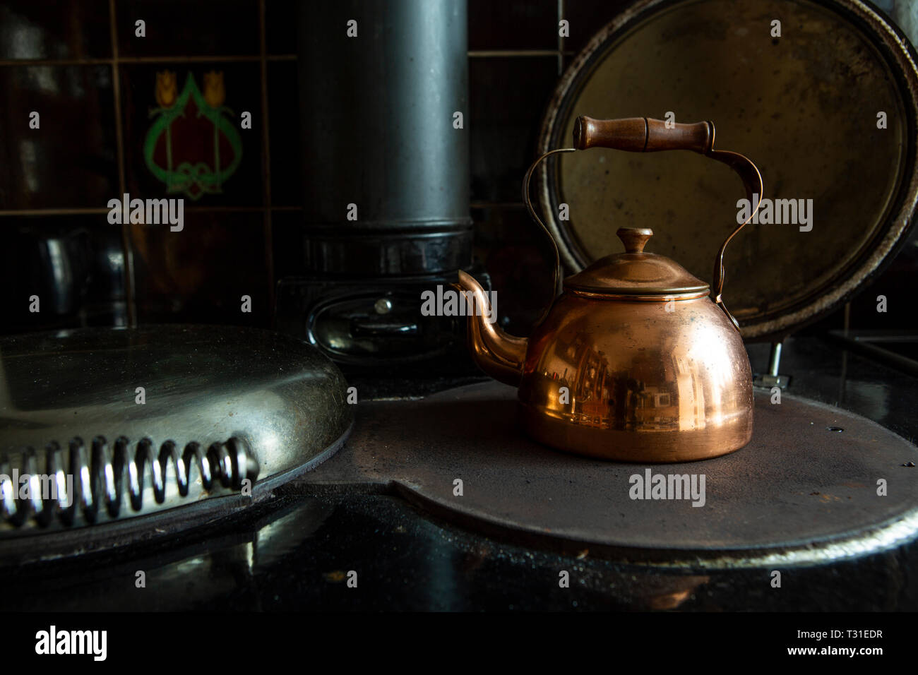 Copper kettle on stove Stock Photo Alamy