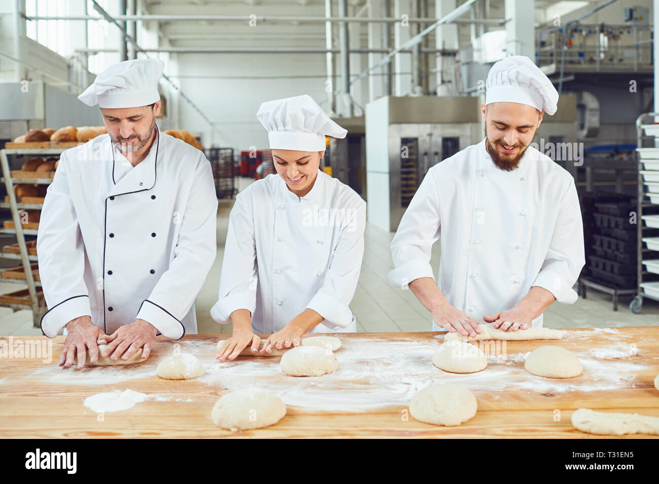 baker weighing bread dough on scale at bakery Stock Photo - Alamy