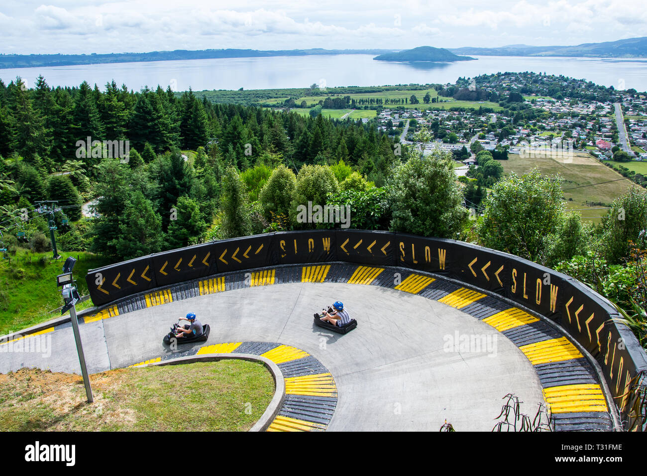 View of two cars at Skyline Luge Rotorua with lake and island in the  background Stock Photo - Alamy