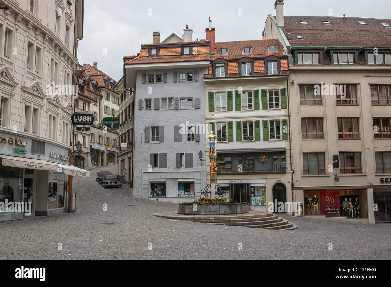 Lausanne, Switzerland - July 2, 2017: Walk through old buildings in historic center of Lausanne city. Summer landscape, sunshine weather, blue sky and Stock Photo