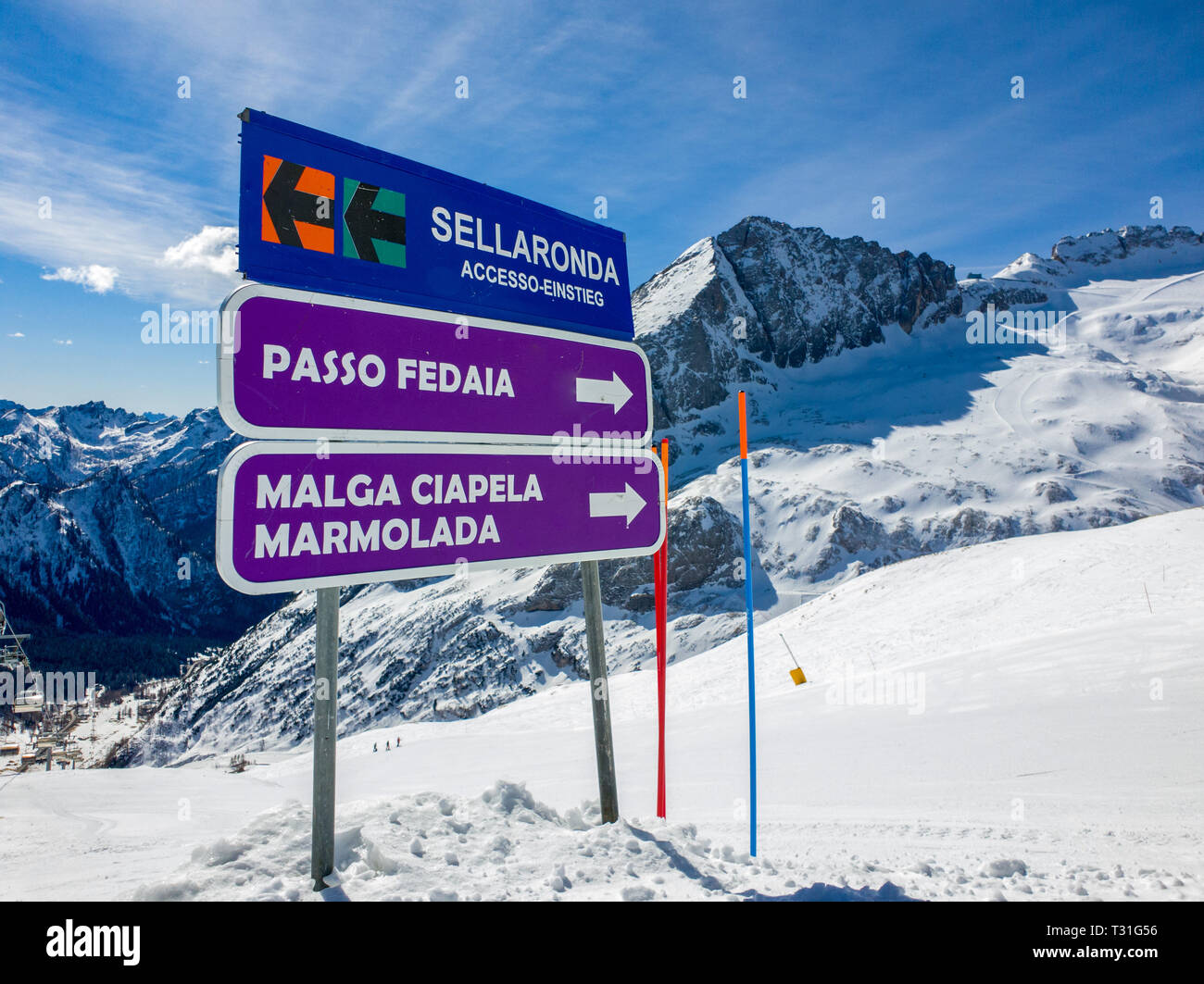 Picture of a sign indicating slopes and towns (Passo Fedaia, Malga Ciapela, Marmolada) and the access to the Sellaronda circuit, Dolomites, Italy Stock Photo